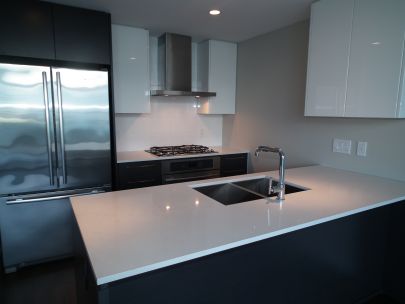 1 Bedroom + Den pet friendly condo in the heart of Olympic Village with huge patio and views of water and mountains!